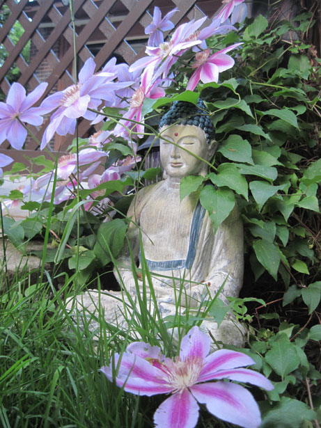 Buddha statue sitting in lotus position in garden